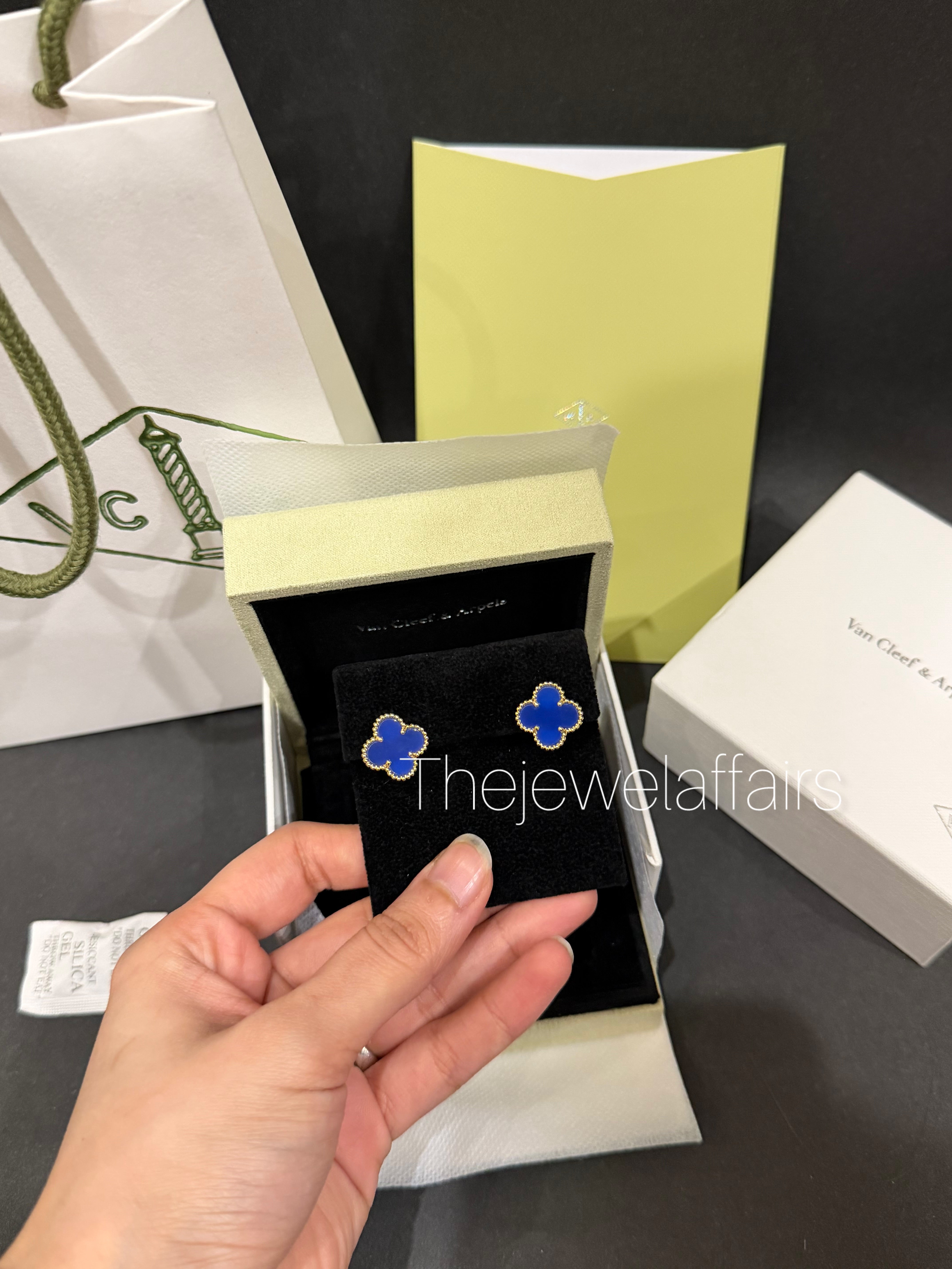 V@ncleef and Arpe!s blue studs with gold hardware