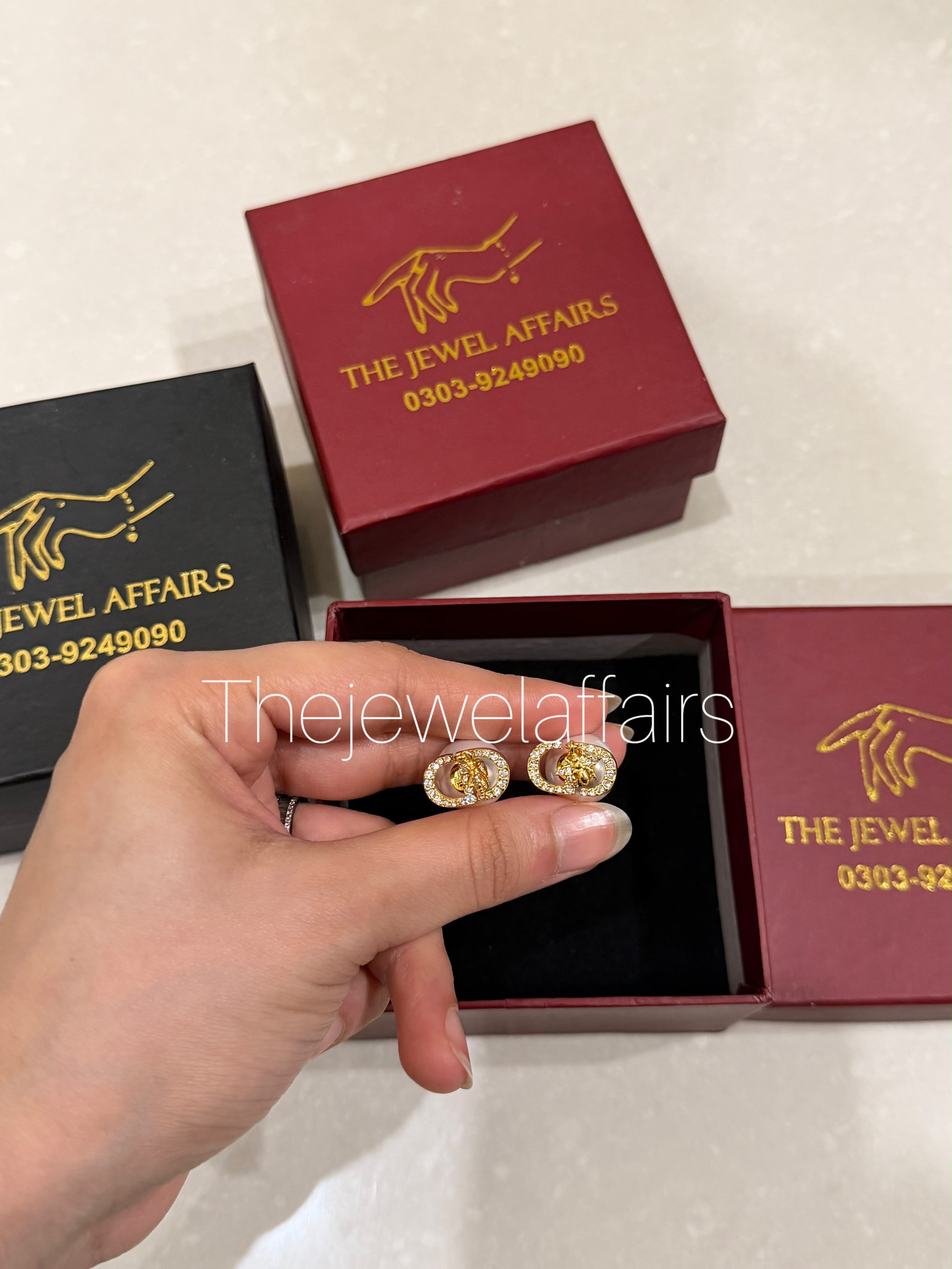 Di0r's Petit CD stud earrings (gold-finish metal with crystal pavé)