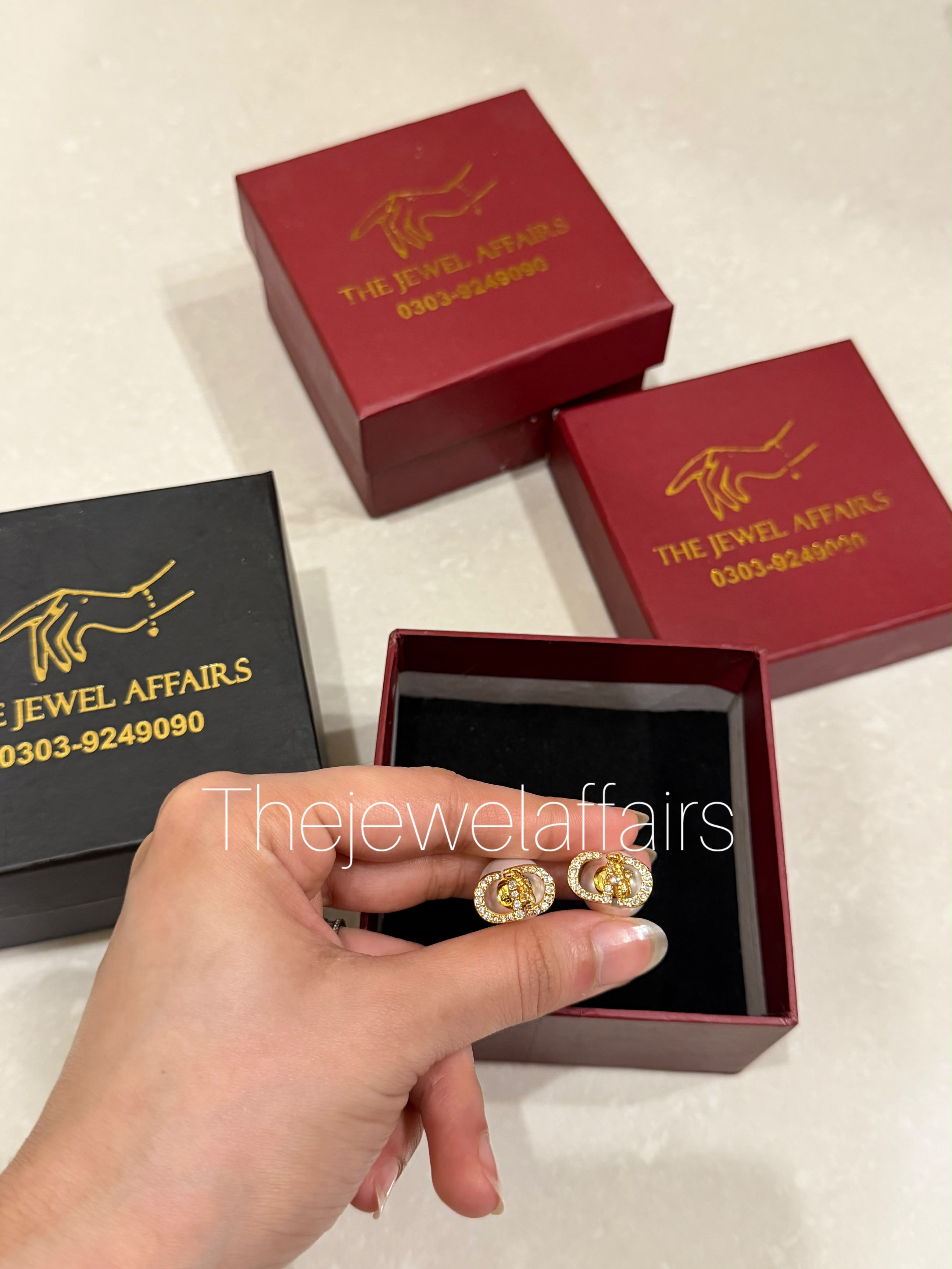 Di0r's Petit CD stud earrings (gold-finish metal with crystal pavé)