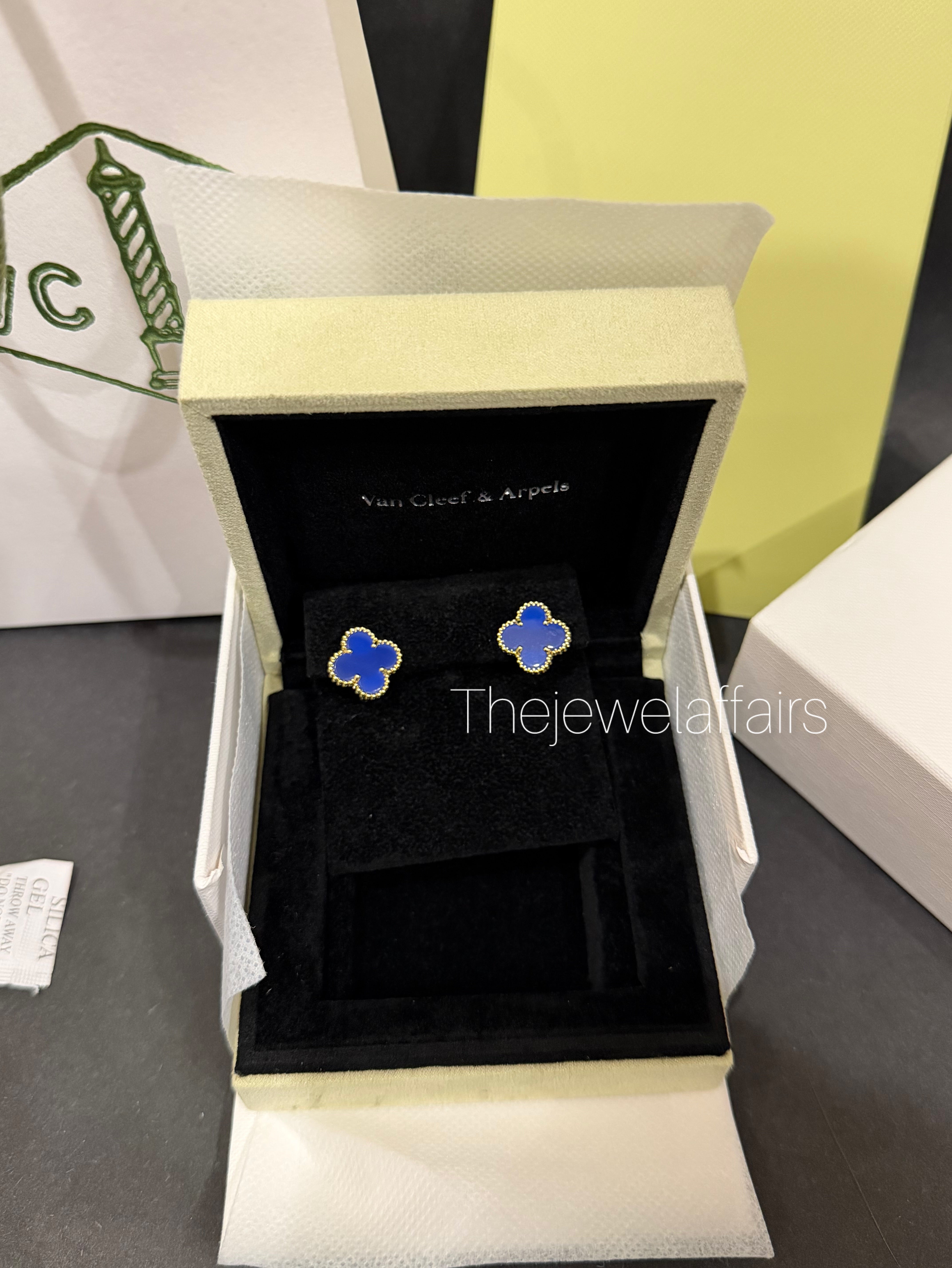 V@ncleef and Arpe!s blue studs with gold hardware