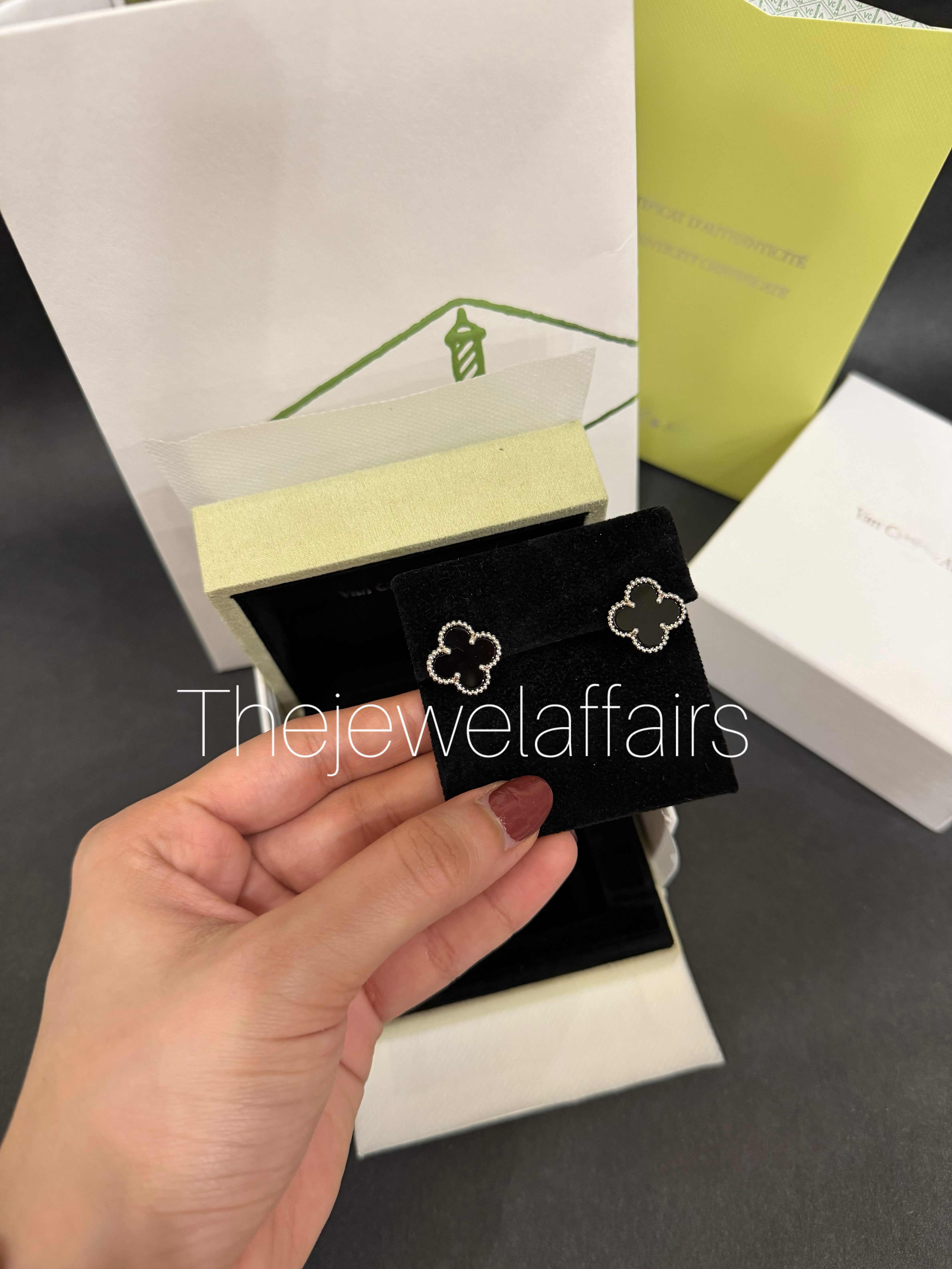 V@ncleef and Arpe!s black studs with gold hardware